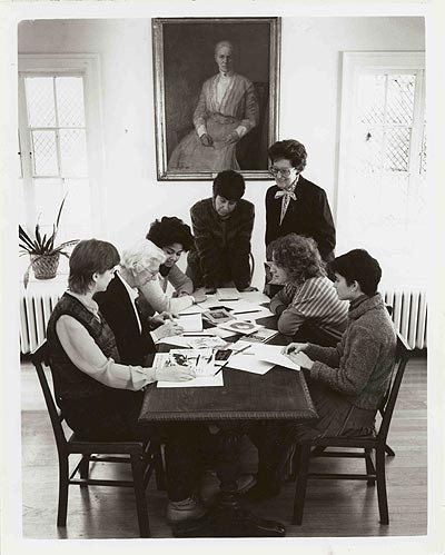 Joan Wallach Scott, founding director of the Pembroke Center for Teaching and Research on Women, beneath a portrait of Sarah Doyle, with alumnae, colleagues, and students.